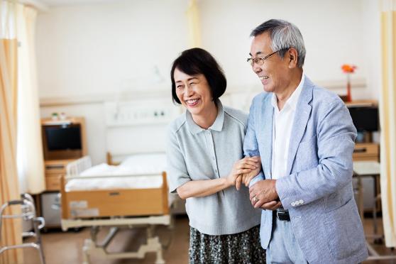Man and woman with arms linked at doctor's office